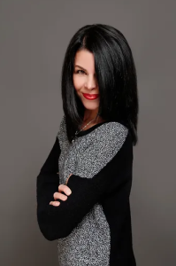 Photograph of Tracie Jensen - a white woman with long black hair in a 3/4 profile shot